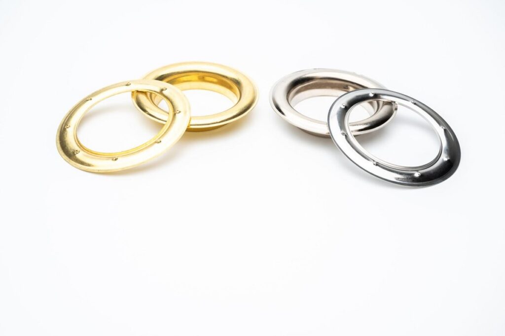 Brass and polished silver-finish curtain grommets and washers